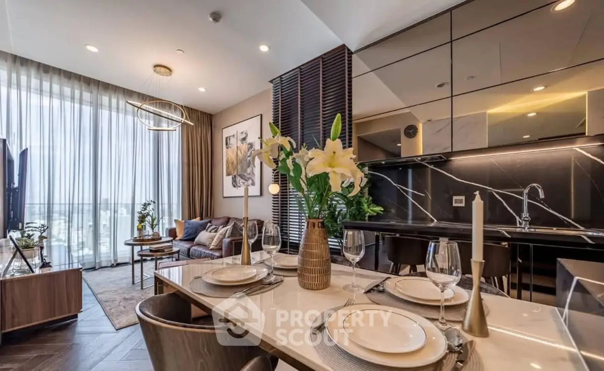 Luxurious open-plan living room and kitchen with elegant decor and large windows.
