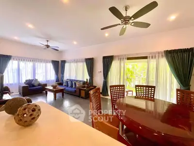 Spacious living room with elegant furniture and large windows for natural light.