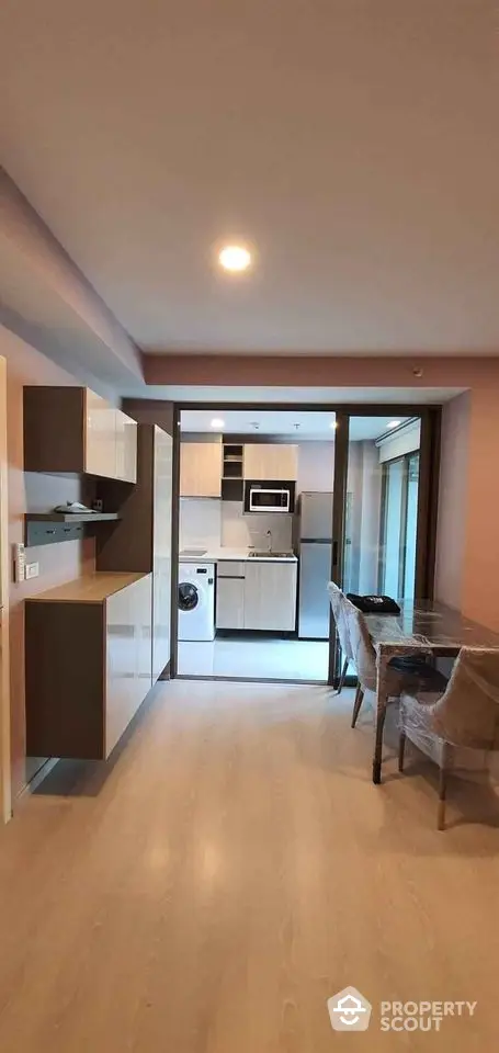 Modern open-plan kitchen and dining area with sleek cabinetry and appliances