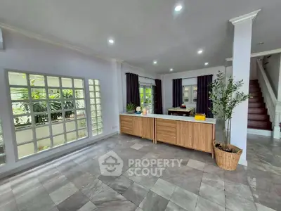 Spacious modern living room with large windows and stylish decor