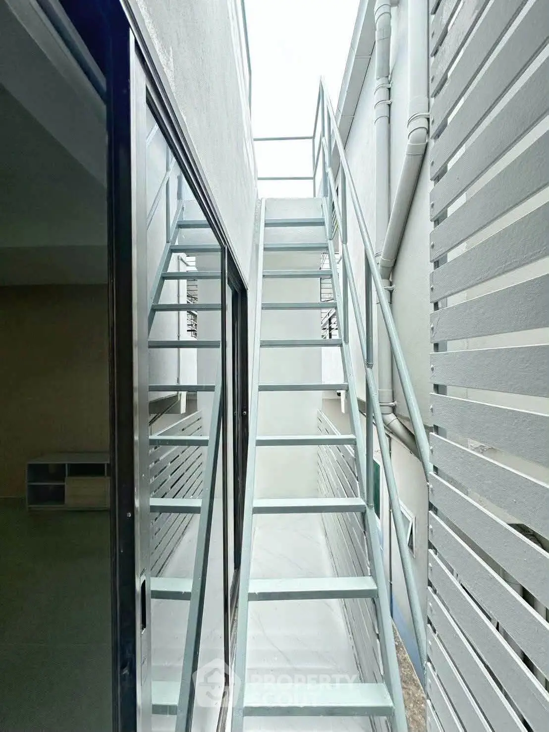 Modern exterior staircase with sleek metal design in a contemporary building setting.
