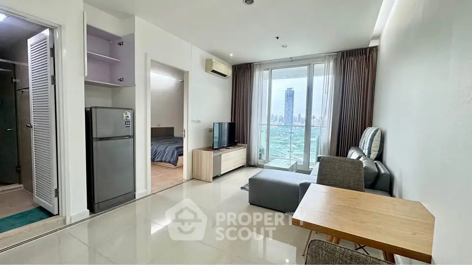 Modern open-plan living room with city view, featuring sleek furniture and natural light.