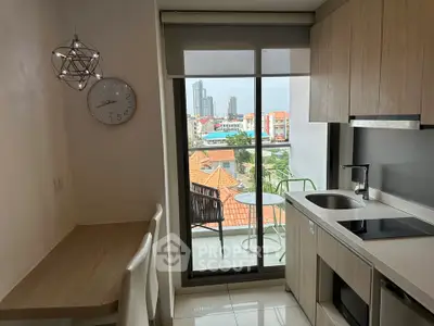 Modern kitchen with balcony view in high-rise apartment