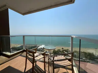 Stunning oceanfront balcony with panoramic sea views and modern seating area.