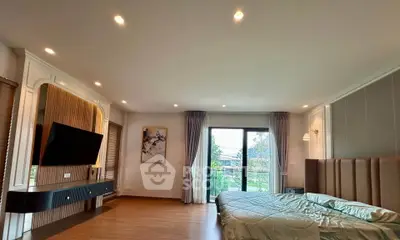 Spacious modern bedroom with balcony and stylish decor