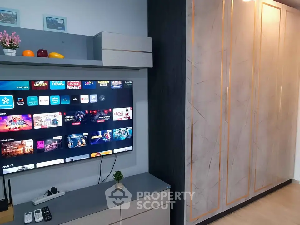 Modern living room with sleek entertainment unit and stylish storage cabinets.