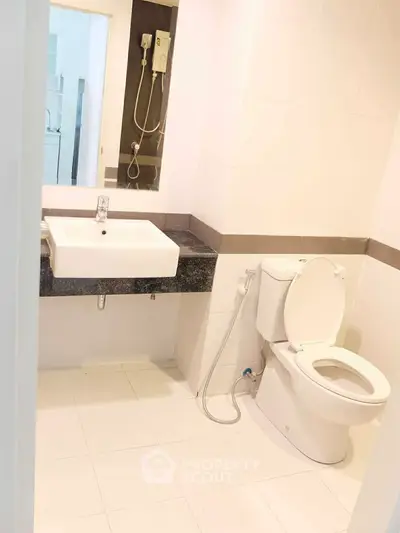 Modern bathroom with sleek fixtures and white tiles