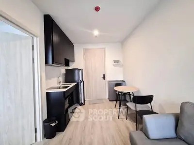 Modern compact apartment with sleek kitchen and cozy dining area, perfect for urban living.