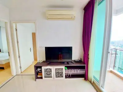 Modern living room with TV, air conditioning, and balcony view in high-rise apartment.