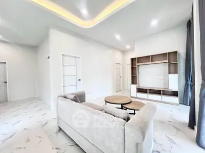 Spacious modern living room with elegant furniture and bright lighting