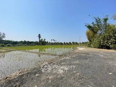 Scenic agricultural land with lush greenery and clear blue sky, ideal for development or farming.