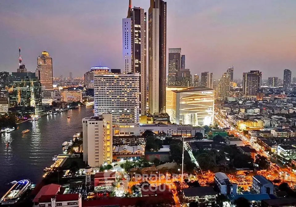 Stunning cityscape view with illuminated skyscrapers and river at dusk, showcasing urban luxury living.