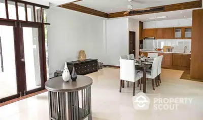 Spacious open-plan dining and kitchen area with modern decor and natural light.