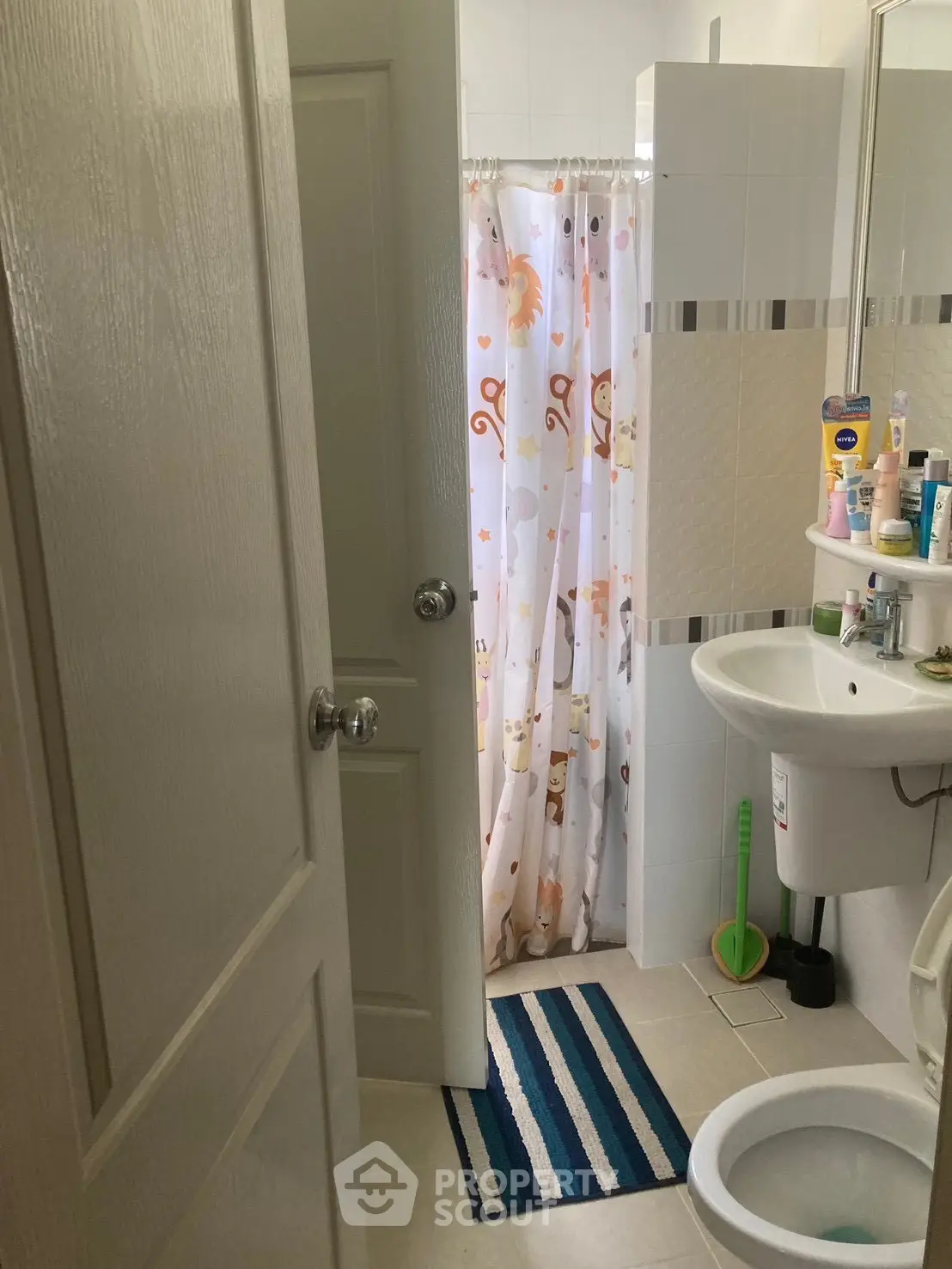 Cozy bathroom with shower curtain and compact sink setup