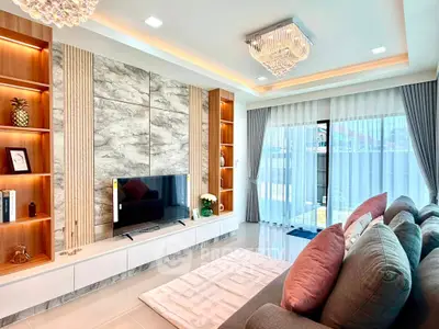 Luxurious living room with elegant decor, large sofa, and modern entertainment center, perfect for relaxation.
