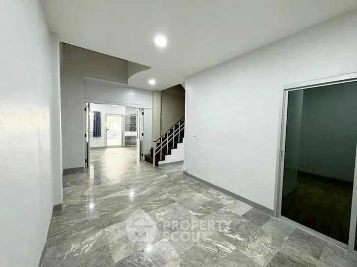 Spacious modern interior with marble flooring and staircase