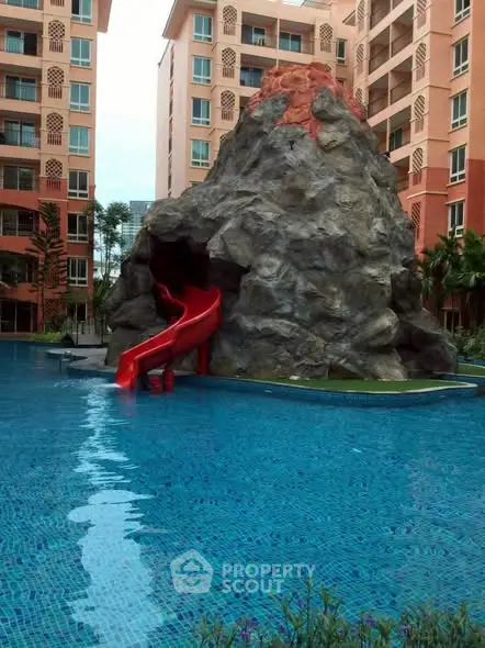 Luxurious residential pool with unique volcano-themed slide feature.