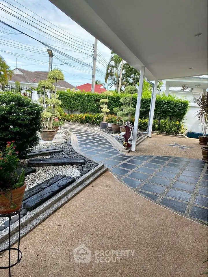 Charming garden pathway with lush greenery and modern design in a serene residential setting.