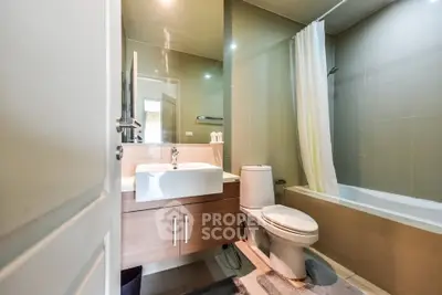 Modern bathroom with sleek fixtures and bathtub in contemporary apartment.