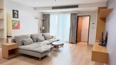 Spacious modern living room with stylish furniture and natural light.