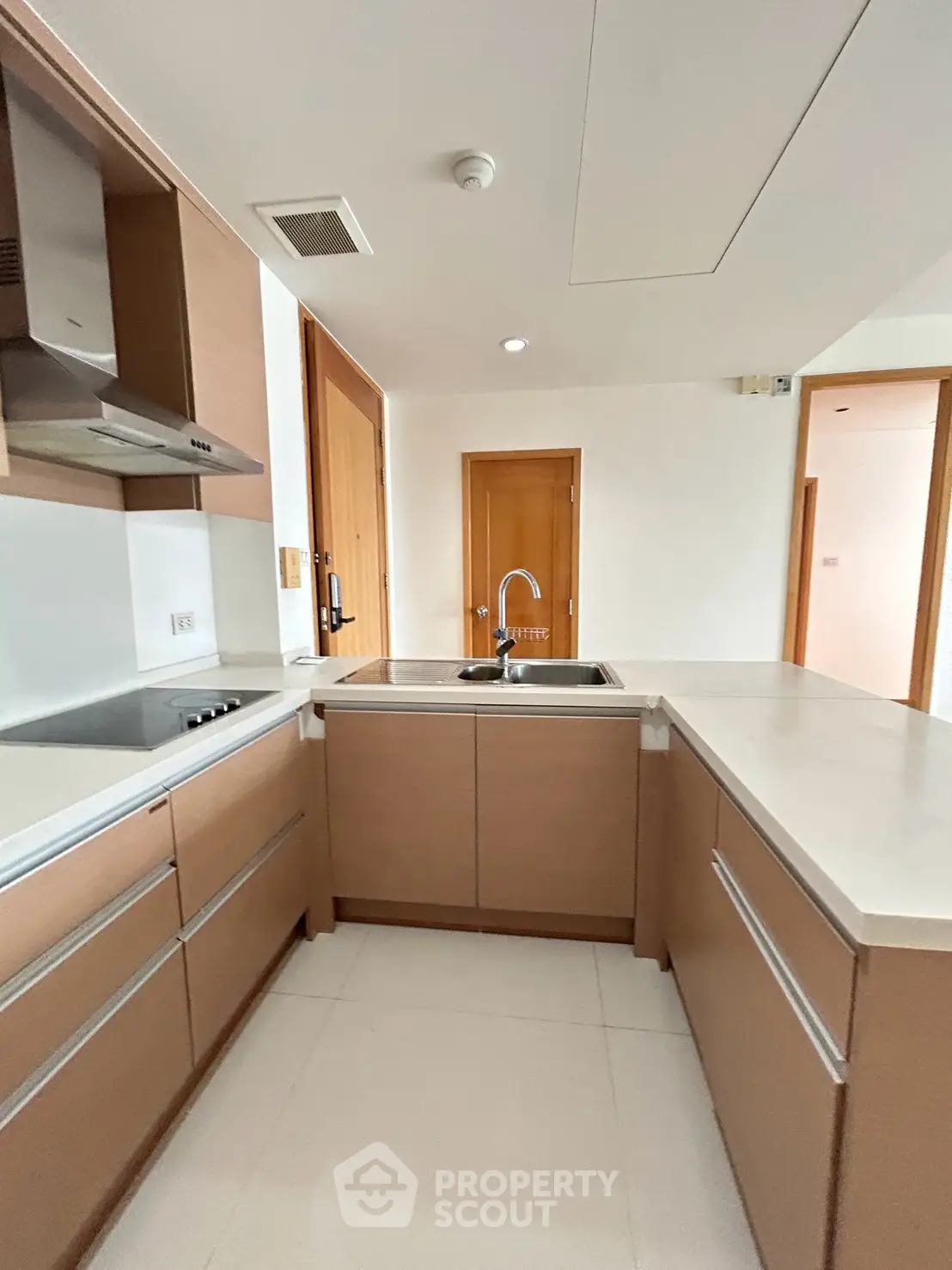 Modern kitchen with sleek cabinetry and integrated appliances in a stylish apartment.