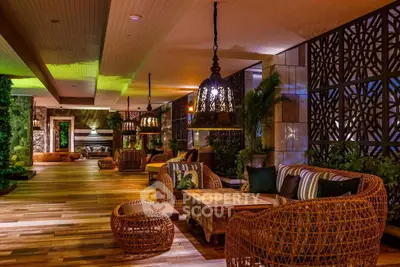 Luxurious outdoor lounge with elegant wicker furniture and ambient lighting