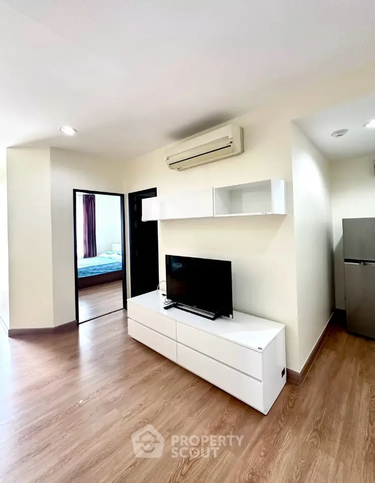 Modern living room with sleek furniture and air conditioning in a stylish apartment.