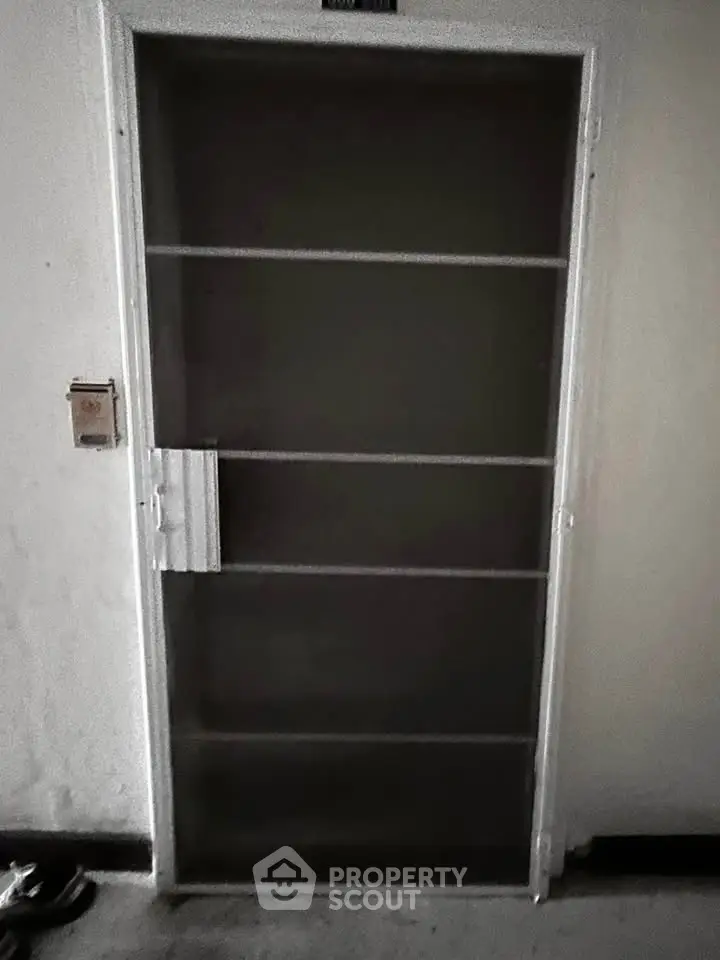 Secure metal door with lock in residential building hallway