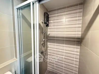 Modern bathroom with sleek shower design and stylish tile accents