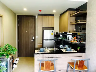 Modern kitchen with sleek design and open layout, featuring stainless steel appliances and stylish wooden cabinetry.