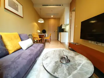 Modern living room with stylish furniture and open kitchen layout