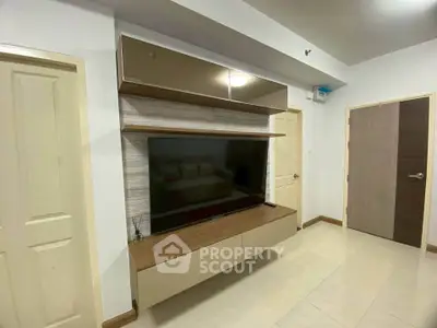 Modern living room with sleek TV unit and neutral decor