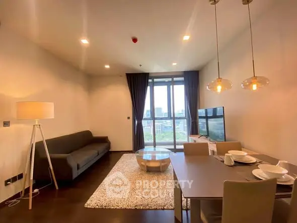 Modern living room with city view, stylish decor, and cozy ambiance.