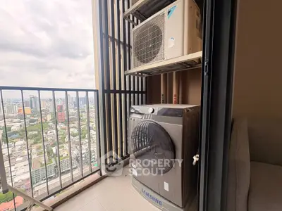 High-rise balcony with city view and modern washing machine setup.