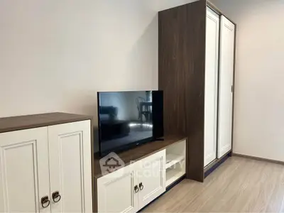 Modern living room with sleek TV stand and stylish wardrobe, perfect for contemporary living.