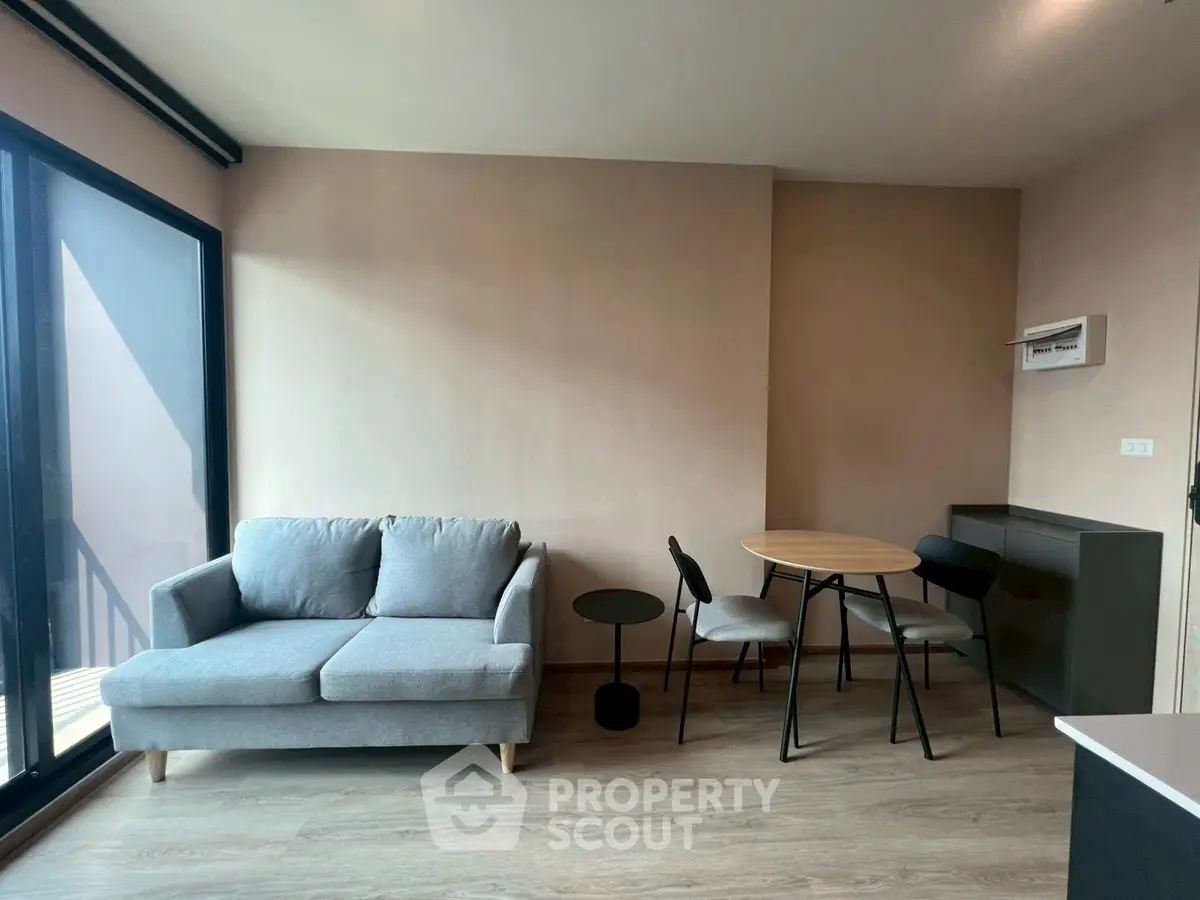 Modern living room with cozy gray sofa and stylish dining area