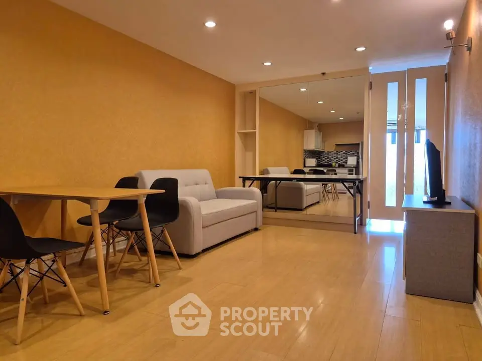 Spacious living room with modern furniture and open layout in a stylish apartment.