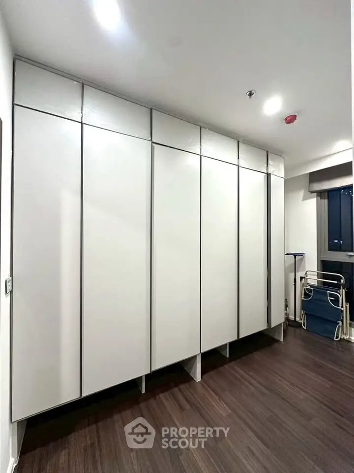 Spacious modern storage room with sleek cabinetry and hardwood flooring