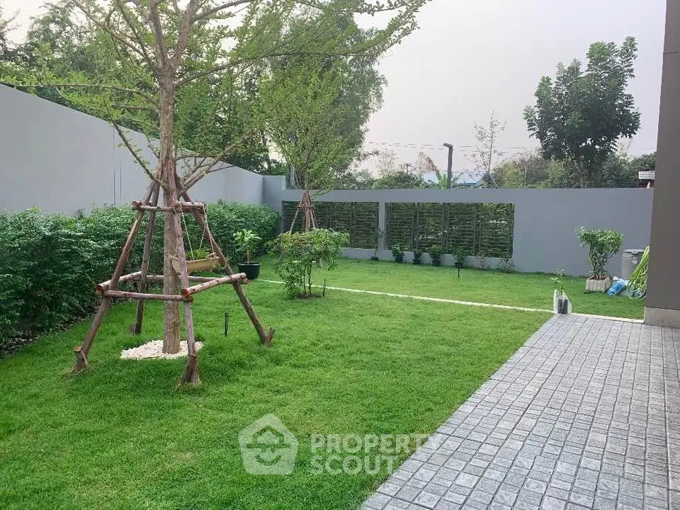 Spacious garden with lush greenery and modern landscaping in a serene residential area.