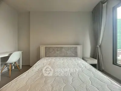 Modern minimalist bedroom with natural light and sleek furnishings