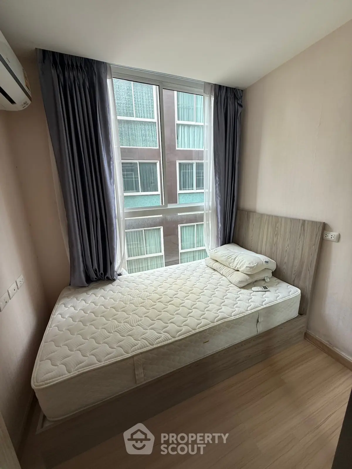 Cozy bedroom with large window and modern decor in urban apartment