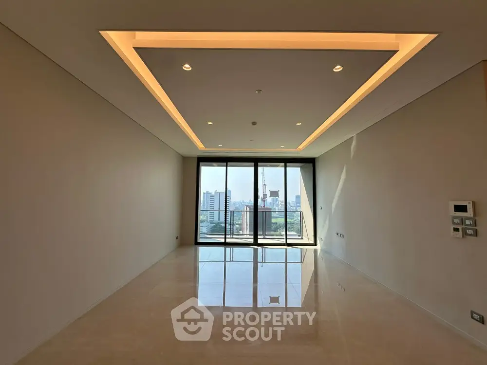 Spacious modern living room with city view and elegant ceiling lighting