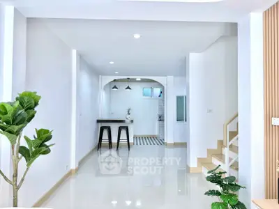 Modern open-plan living area with sleek design and natural light