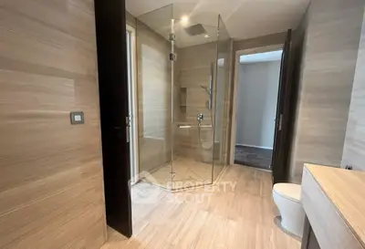 Luxurious modern bathroom with glass shower and elegant wood paneling
