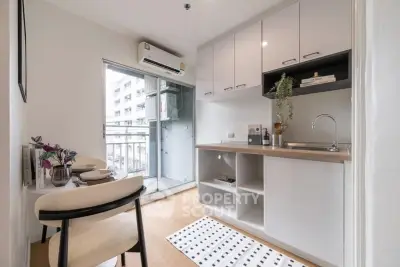 Modern kitchen with open layout and balcony access in urban apartment