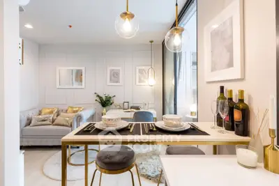 Modern open-plan living and dining area with elegant decor and stylish lighting.