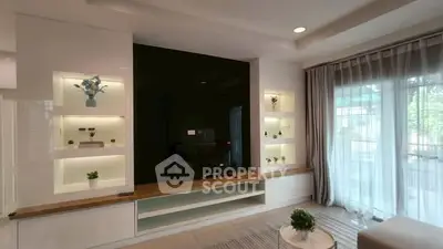 Modern living room with sleek TV unit and large window view