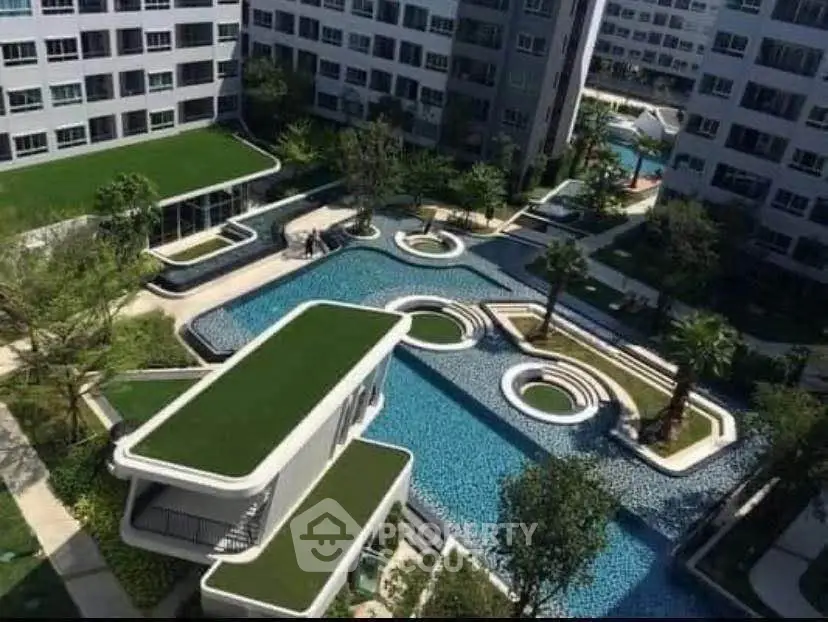 Luxurious modern apartment complex with stunning pool and landscaped gardens.