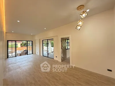 Spacious modern living room with elegant lighting and large windows