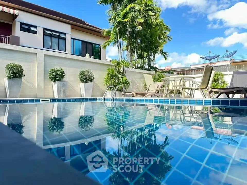 Luxurious poolside view with modern architecture and lush greenery, perfect for relaxation and leisure.